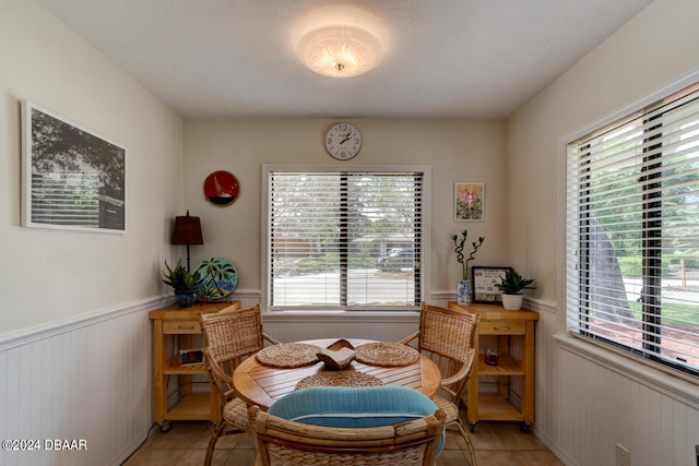 dining space with light tile patterned flooring and a healthy amount of sunlight