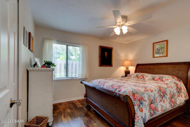 bedroom with ceiling fan and dark hardwood / wood-style floors