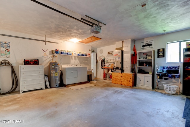 garage featuring electric water heater, a garage door opener, and washer and dryer