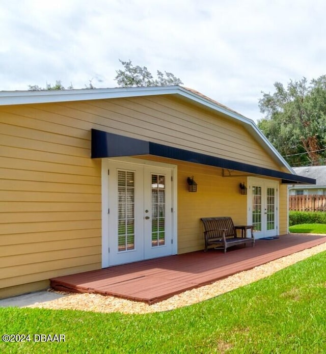 rear view of property with french doors and a wooden deck