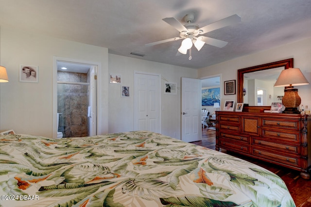 bedroom with connected bathroom, dark wood-type flooring, and ceiling fan