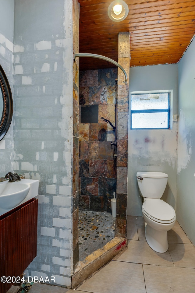 bathroom featuring vanity, tiled shower, tile patterned floors, and wood ceiling