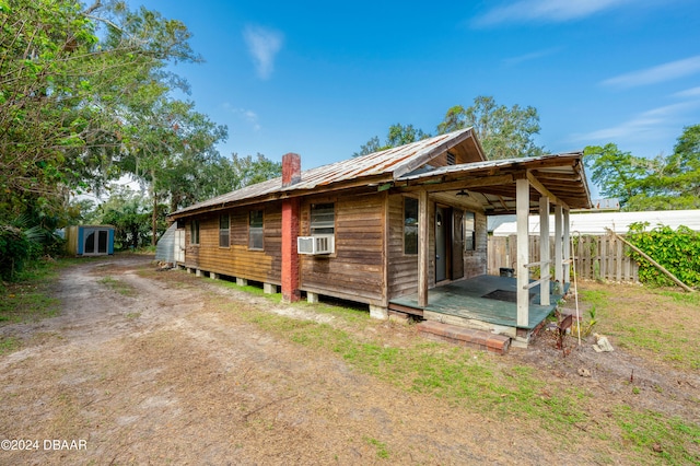 exterior space featuring a storage shed and cooling unit