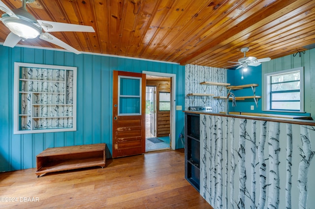 interior space featuring wood-type flooring, wooden ceiling, and ceiling fan