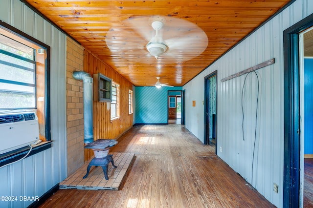 corridor with hardwood / wood-style flooring, wooden ceiling, and plenty of natural light