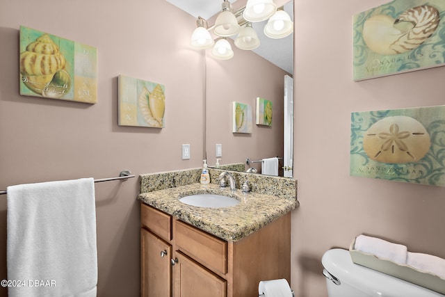 bathroom featuring toilet and vanity