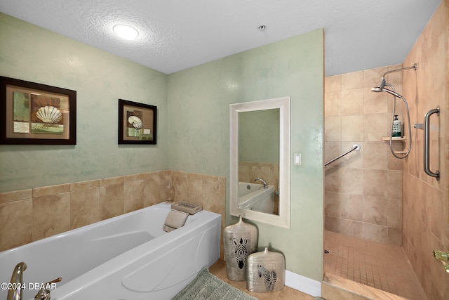 bathroom with a textured ceiling and plus walk in shower