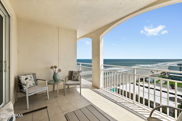 balcony with a beach view and a water view