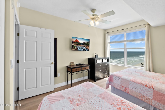 bedroom with light hardwood / wood-style floors and ceiling fan