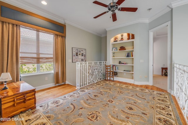 100 Emerald Lake Dr, Palm Coast, FL 32137 - living area featuring wood finished floors, an upstairs landing, ornamental molding, ceiling fan, and baseboards
