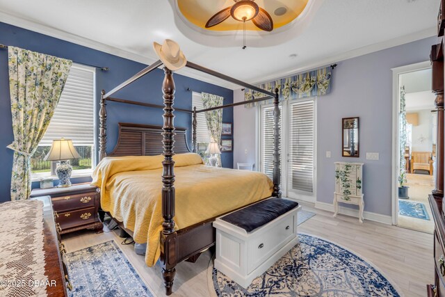 100 Emerald Lake Dr, Palm Coast, FL 32137 - bedroom featuring access to exterior, light wood-style floors, baseboards, a ceiling fan, and ornamental molding