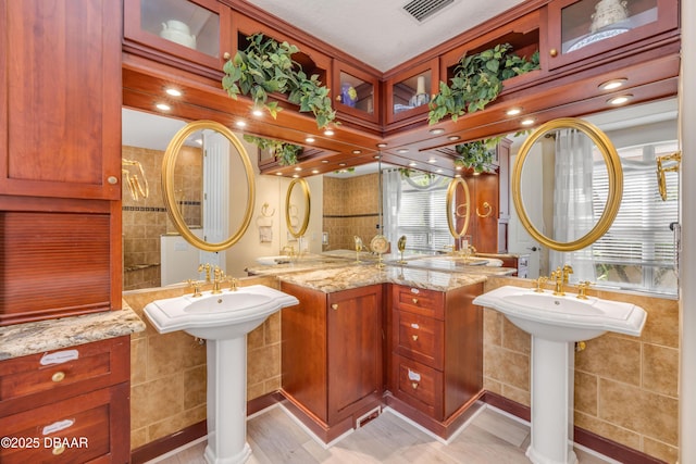 100 Emerald Lake Dr, Palm Coast, FL 32137 - full bathroom with two sinks and tile walls