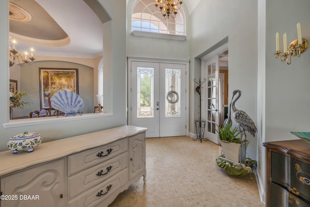 100 Emerald Lake Dr, Palm Coast, FL 32137 - entryway with a chandelier, arched walkways, plenty of natural light, and light tile patterned floors