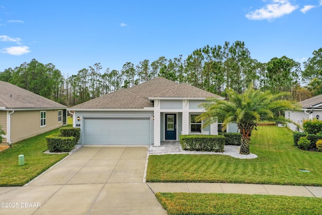 view of front of property featuring a front yard and a garage