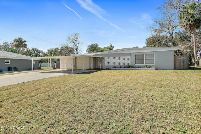 view of front facade with a carport, a garage, and a front lawn