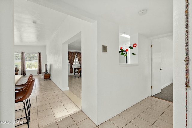 hall featuring light tile patterned floors