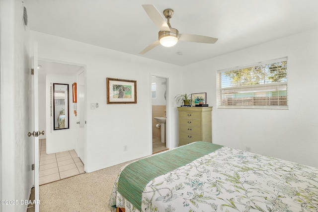 bedroom featuring ensuite bath, ceiling fan, and light tile patterned flooring