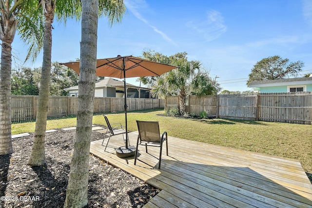 wooden deck featuring a yard