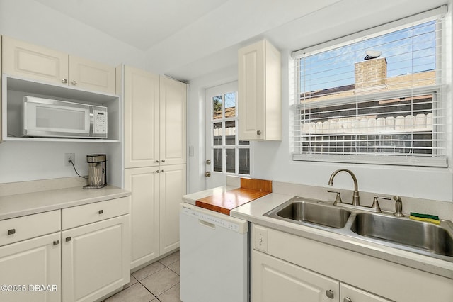 kitchen featuring white cabinetry, sink, and white appliances