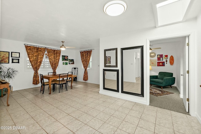 carpeted dining area with ceiling fan