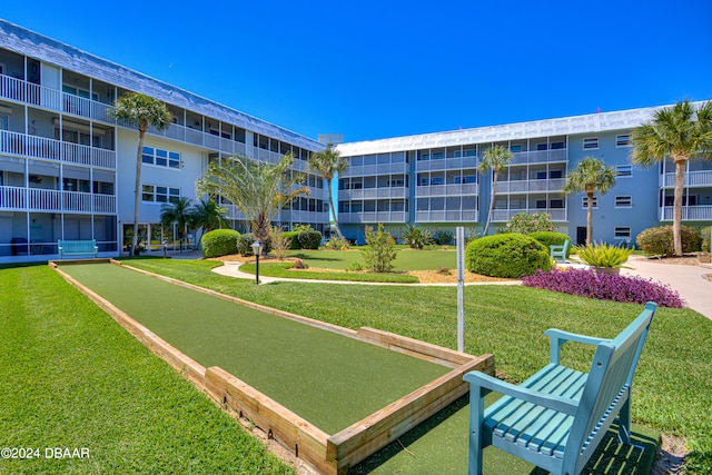 view of property's community with a lawn