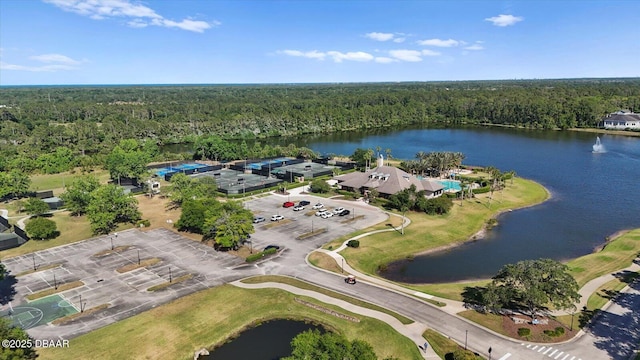 aerial view with a water view and a wooded view