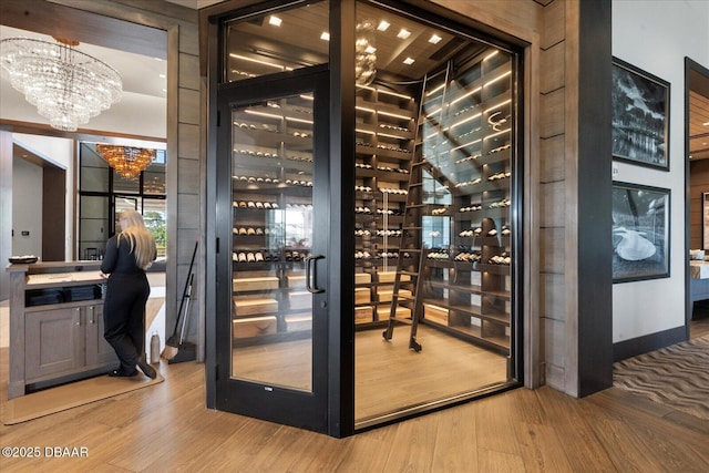 wine area with an inviting chandelier and wood finished floors
