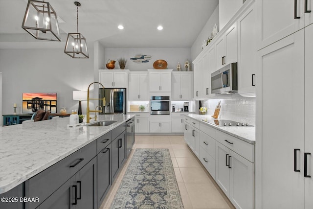 kitchen featuring backsplash, pendant lighting, appliances with stainless steel finishes, white cabinets, and recessed lighting