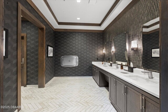 full bathroom with a sink, ornamental molding, and double vanity