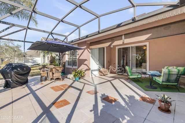 view of patio / terrace with a grill and glass enclosure