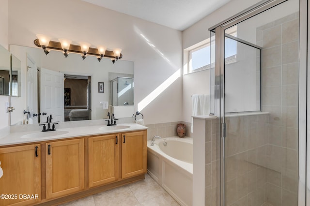 bathroom with tile patterned flooring, vanity, and separate shower and tub