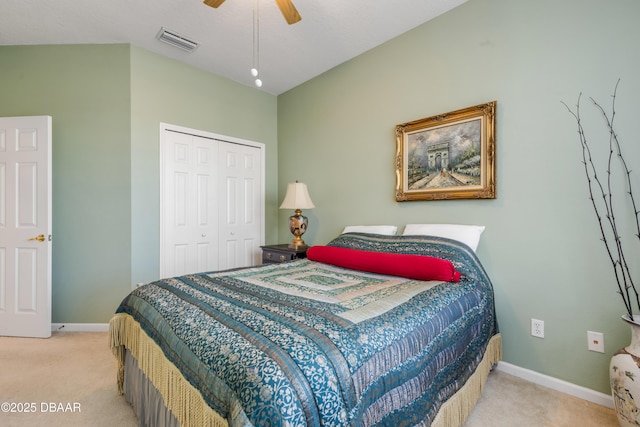 bedroom featuring ceiling fan, light colored carpet, and a closet