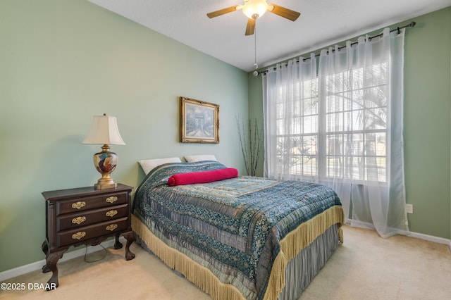 carpeted bedroom featuring multiple windows and ceiling fan