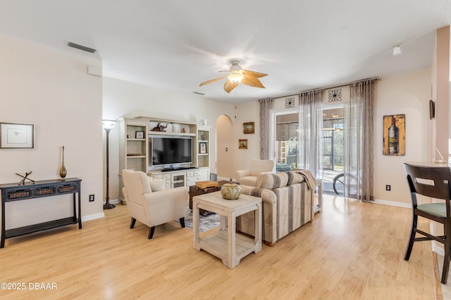 living room featuring ceiling fan and light wood-type flooring