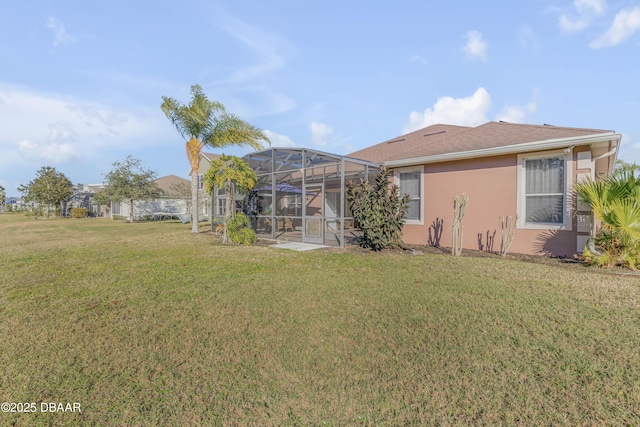 rear view of house featuring a lanai and a yard