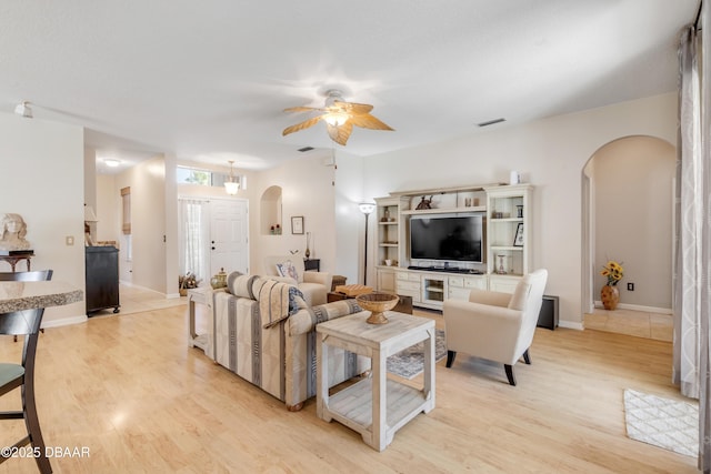 living room featuring ceiling fan and light wood-type flooring