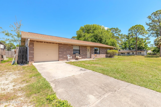 ranch-style house featuring driveway, an attached garage, fence, a front yard, and brick siding
