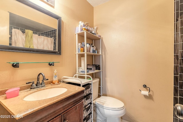 full bathroom featuring toilet, vanity, and a shower with shower curtain