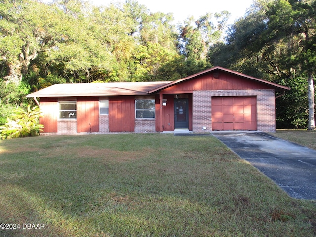 ranch-style home featuring a garage and a front yard