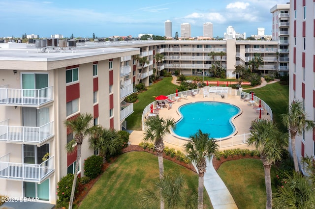 view of swimming pool with a yard and a patio