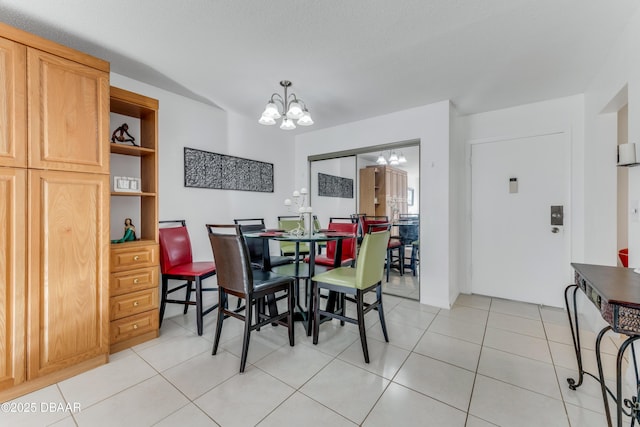 dining space featuring an inviting chandelier and light tile patterned flooring