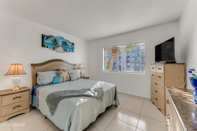 bedroom featuring light tile patterned floors and a textured ceiling