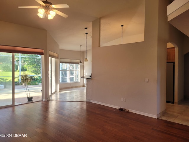 spare room with hardwood / wood-style flooring, ceiling fan, and vaulted ceiling