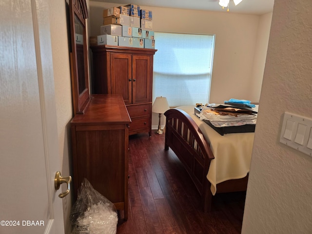 bedroom with dark wood-type flooring