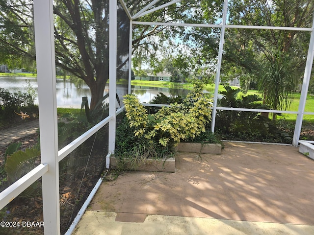 unfurnished sunroom with a water view