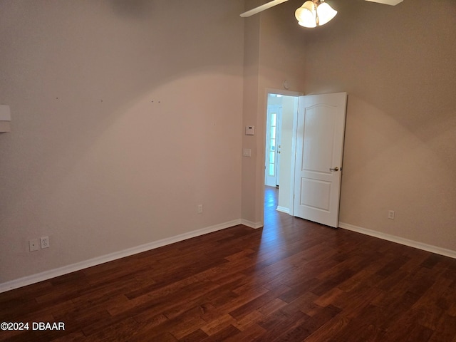 empty room featuring ceiling fan and dark wood-type flooring