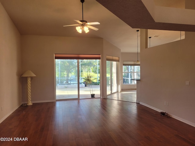 unfurnished living room with ceiling fan and dark wood-type flooring