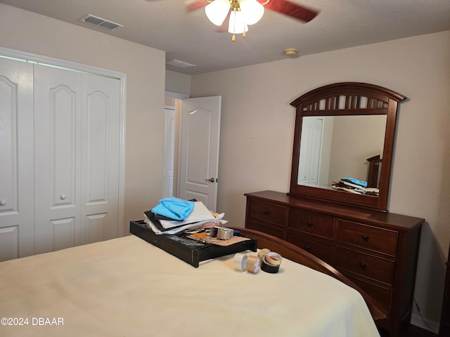 bedroom with ceiling fan and a closet