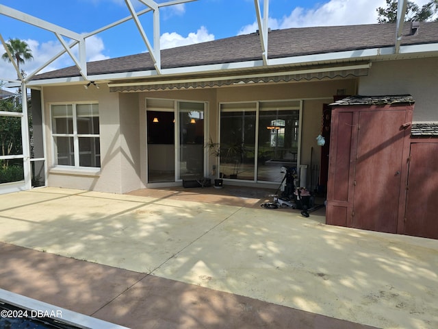 back of house featuring a lanai and a patio area