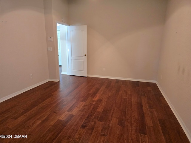 unfurnished room featuring dark hardwood / wood-style flooring